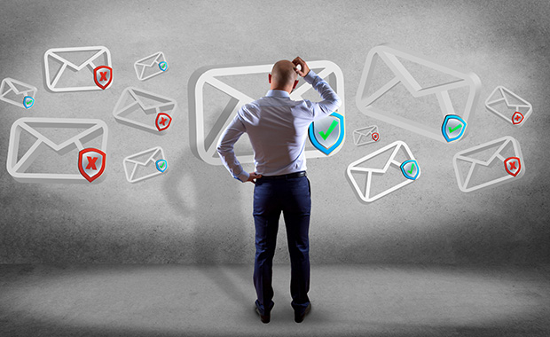 Man viewed from behind looking at email icons in air