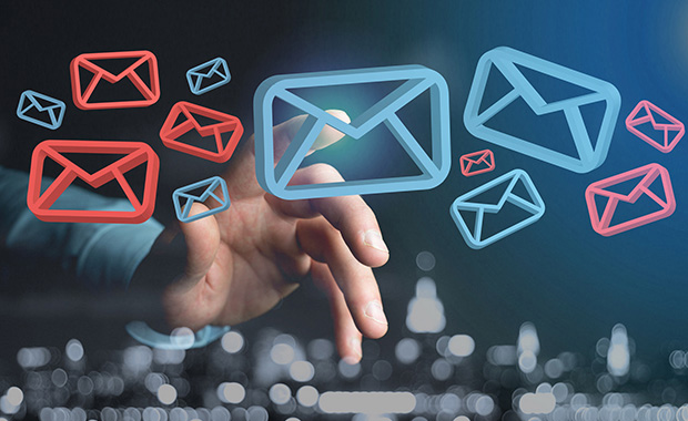 Hand pointing at floating red and blue email icons