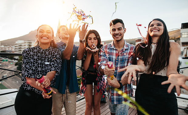 Group of young people celebrating on a balcony