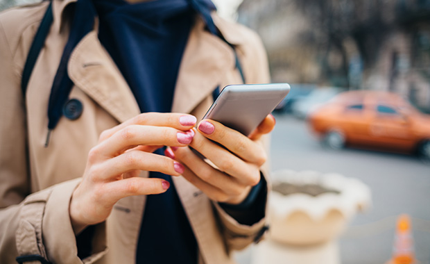 Woman’s hands holding smartphone and texting