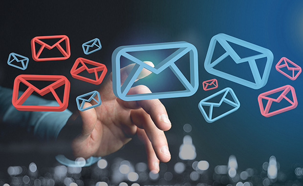 Hand pointing at floating red and blue email icons