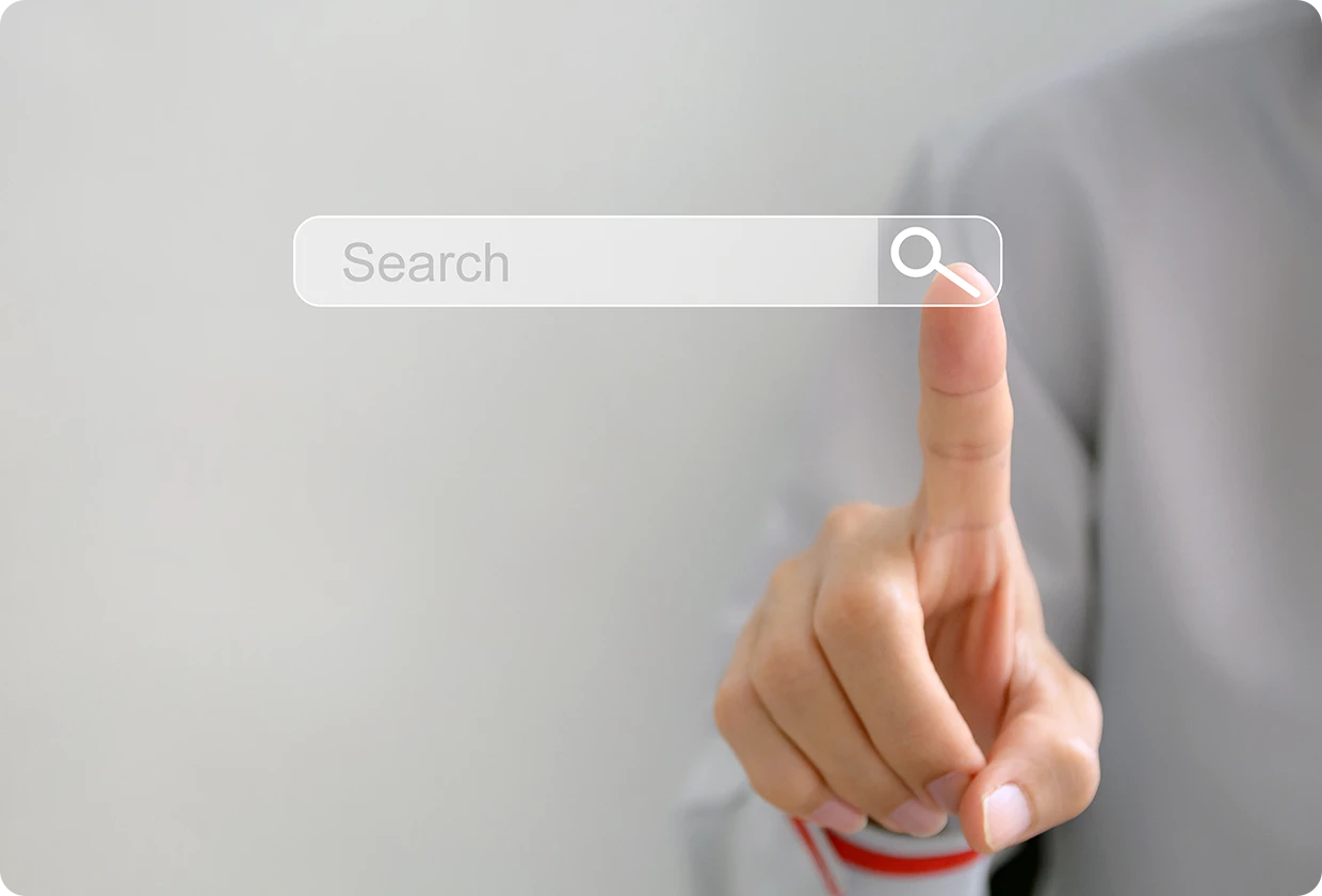 A person’s finger is touching a floating digital search bar.