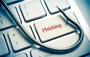 Keyboard with fishing hook symbolizing phishing