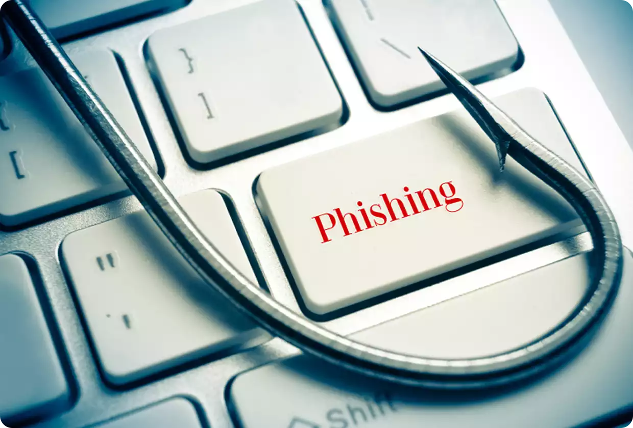 Keyboard with fishing hook symbolizing phishing