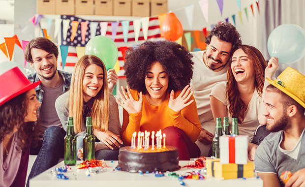 Smiling young woman celebrating birthday with friends