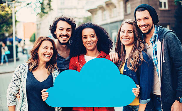 Smiling group of people holding a blue cloud symbol