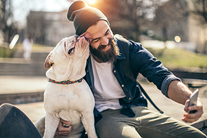 Smiling bearded man takes selfie with his dog