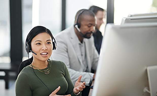 Customer support agent wearing headset and talking to customer