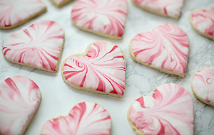 Rows of frosted heart-shaped cookies