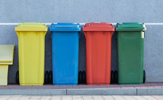 Row of recycling bins on sidewalk