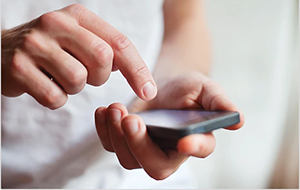 Person holding a smartphone about to tap the screen.