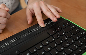 Hands using a Braille computer keyboard