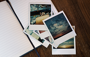 Old Polaroid photos scattered on wooden surface