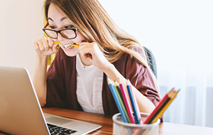 Woman looking at laptop frustrated