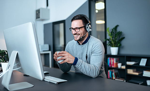 Man with headphones participates in video call 