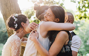 Women hug each other at a wedding