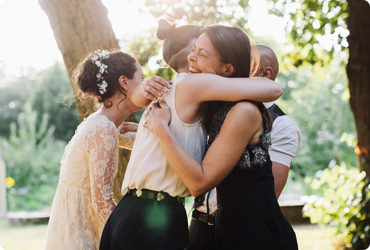 Women hug each other at a wedding