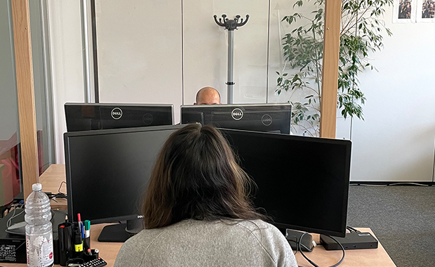 Office with two people working at computers