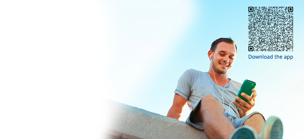 man with smartphone and headphones on a rooftop