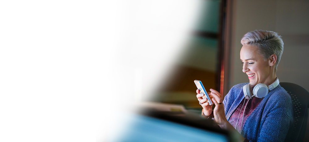 smiling woman setting up password on smartphone